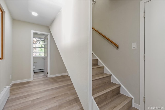 1120 Hartford Dr, Boulder, CO 80305 - stairs featuring a baseboard radiator and wood finished floors