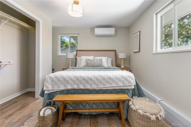 1120 Hartford Dr, Boulder, CO 80305 - bedroom with a wall mounted air conditioner and wood finished floors