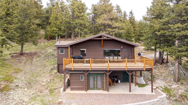73 Elk Way, Drake, CO 80515 - rear view of property featuring a wooden deck, a patio area, and log exterior