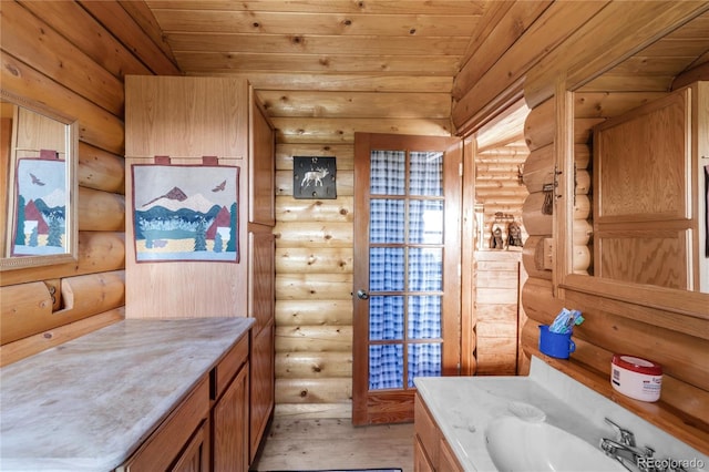 73 Elk Way, Drake, CO 80515 - bathroom featuring rustic walls, wood ceiling, vanity, and wood finished floors
