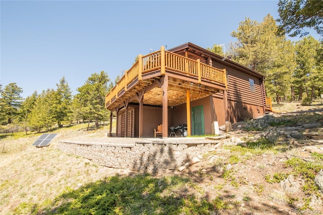 73 Elk Way, Drake, CO 80515 - rear view of property with a wooden deck and stucco siding