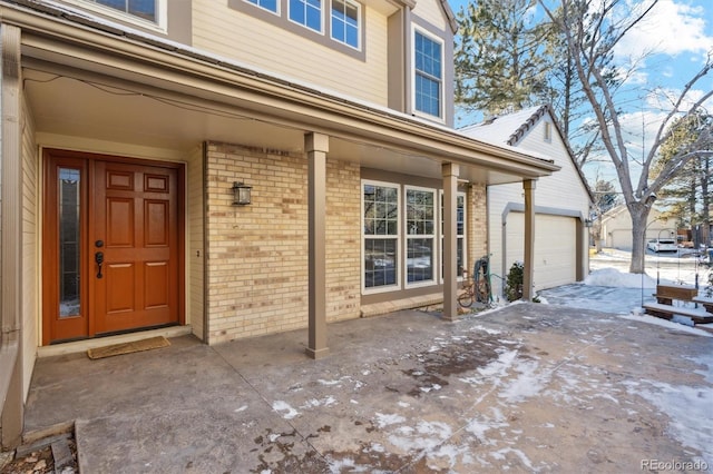 doorway to property featuring covered porch and a garage