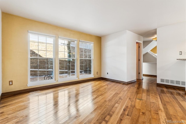 empty room with a healthy amount of sunlight and light wood-type flooring