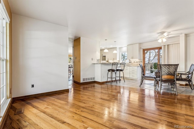 interior space featuring light hardwood / wood-style floors and ceiling fan