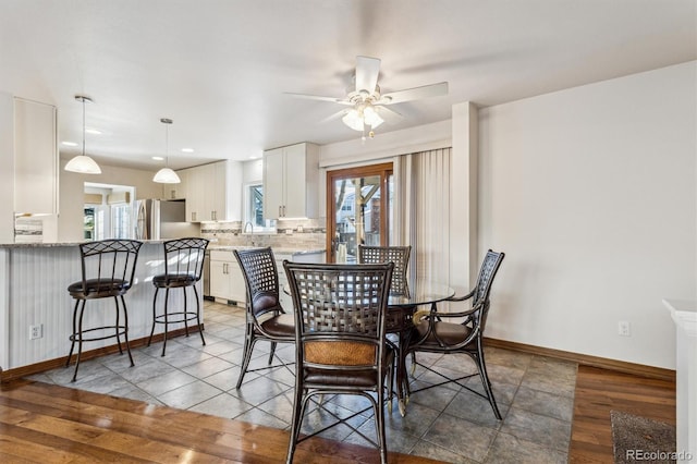 dining room featuring hardwood / wood-style flooring, a wealth of natural light, and ceiling fan