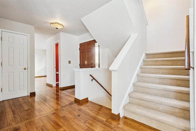 stairs with hardwood / wood-style flooring