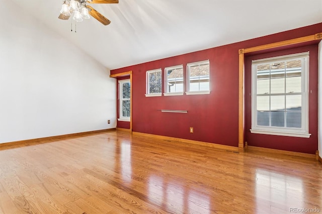 empty room featuring vaulted ceiling, ceiling fan, and light hardwood / wood-style floors