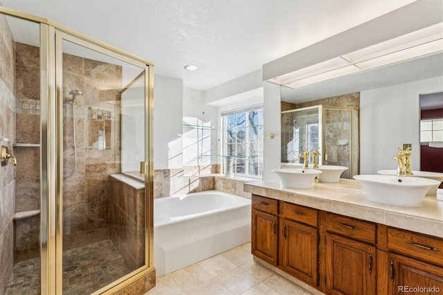 bathroom featuring vanity, tile patterned floors, and shower with separate bathtub