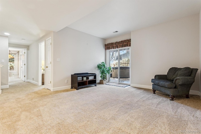 living area with light colored carpet