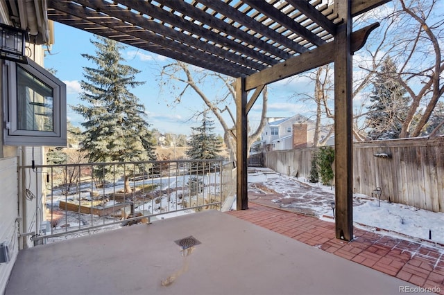 snow covered patio with a pergola