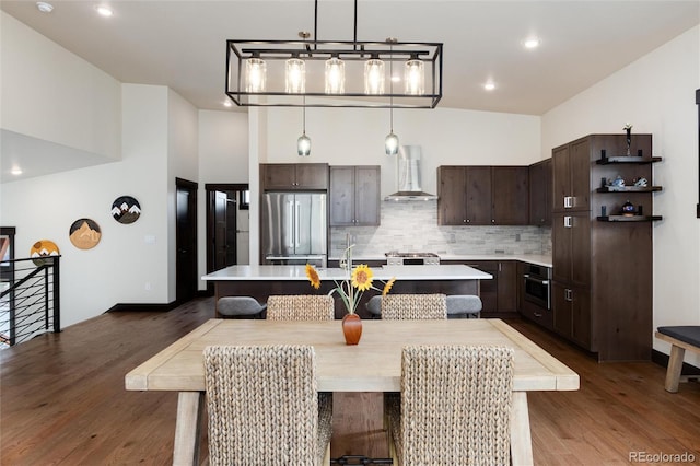 17 Vendette Rd, Silverthorne, CO 80498 - kitchen with appliances with stainless steel finishes, wall chimney exhaust hood, dark brown cabinetry, light countertops, and recessed lighting