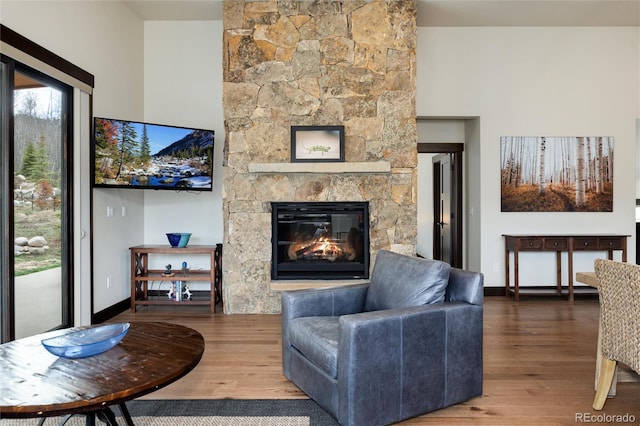 17 Vendette Rd, Silverthorne, CO 80498 - living area with wood finished floors, a stone fireplace, and baseboards