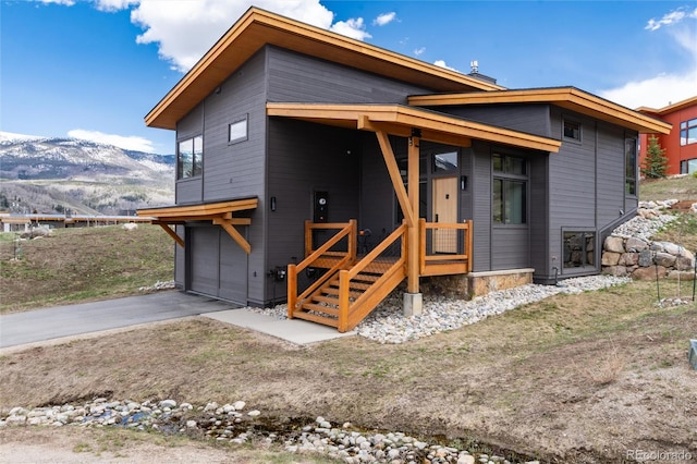 17 Vendette Rd, Silverthorne, CO 80498 - rear view of house with a mountain view, asphalt driveway, and an attached garage