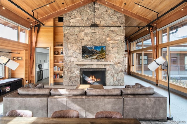 17 Vendette Rd, Silverthorne, CO 80498 - living room featuring wood ceiling with exposed beams, high vaulted ceiling, a stone fireplace, wooden walls, and tile patterned flooring