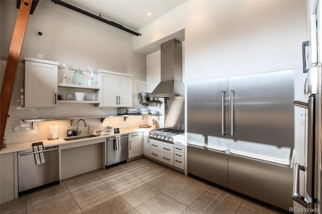 17 Vendette Rd, Silverthorne, CO 80498 - kitchen featuring a sink, appliances with stainless steel finishes, wall chimney exhaust hood, decorative backsplash, and light countertops