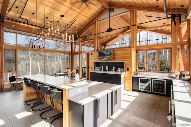 17 Vendette Rd, Silverthorne, CO 80498 - kitchen with wood ceiling with exposed beams, a chandelier, high vaulted ceiling, plenty of natural light, and wine cooler