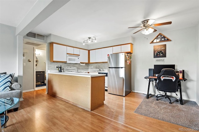 3663 S Sheridan Blvd Unit O15, Denver, CO 80235 - kitchen featuring freestanding refrigerator, white microwave, ceiling fan, range, and tasteful backsplash
