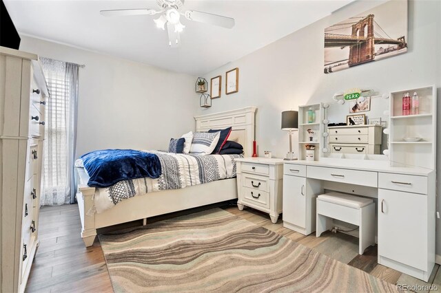 3663 S Sheridan Blvd Unit O15, Denver, CO 80235 - bedroom with light wood-style floors and a ceiling fan
