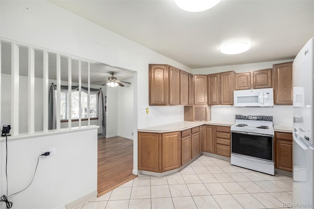 kitchen featuring tasteful backsplash, light tile patterned floors, white appliances, and ceiling fan