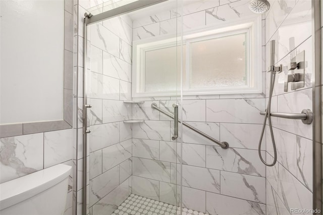 bathroom featuring an enclosed shower, tile walls, and toilet