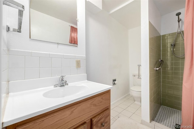 bathroom with vanity, tile patterned floors, toilet, and a tile shower