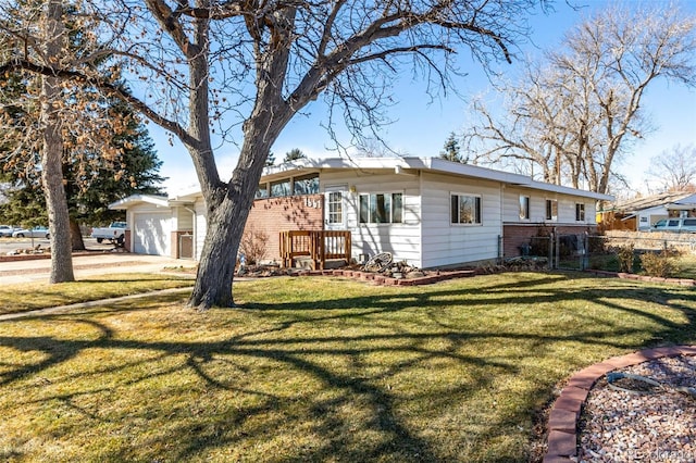 back of house with a garage and a lawn