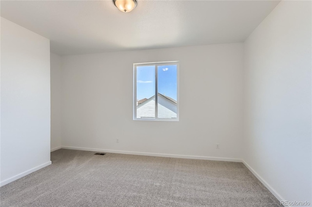 spare room with visible vents, baseboards, and carpet floors