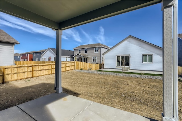 exterior space with a patio area, a residential view, and fence