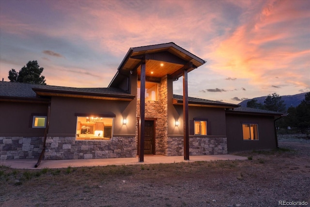 17158 County Road 363, Buena Vista, CO 81211 - view of front of home featuring stone siding, stucco siding, and a patio