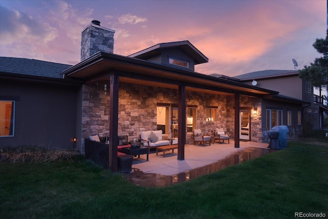 17158 County Road 363, Buena Vista, CO 81211 - back of property at dusk featuring an outdoor living space, a chimney, a lawn, and a patio