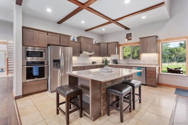 17158 County Road 363, Buena Vista, CO 81211 - kitchen featuring appliances with stainless steel finishes, tasteful backsplash, a breakfast bar area, beamed ceiling, and coffered ceiling