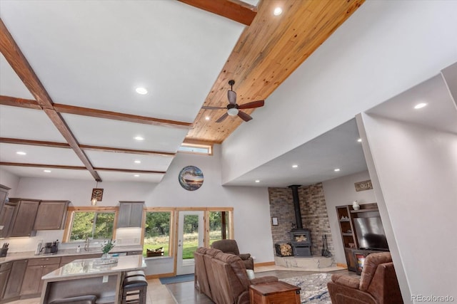 17158 County Road 363, Buena Vista, CO 81211 - living room featuring a wood stove, recessed lighting, a ceiling fan, a towering ceiling, and beamed ceiling