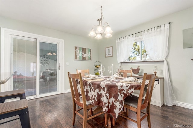 dining room featuring baseboards, an inviting chandelier, and wood finished floors