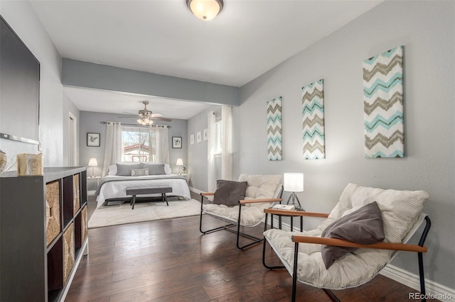 bedroom featuring dark wood-type flooring, a ceiling fan, and baseboards