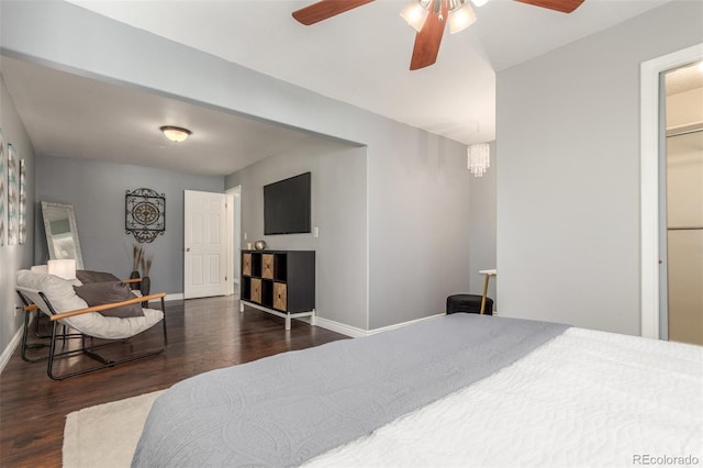 bedroom with ceiling fan, baseboards, and wood finished floors