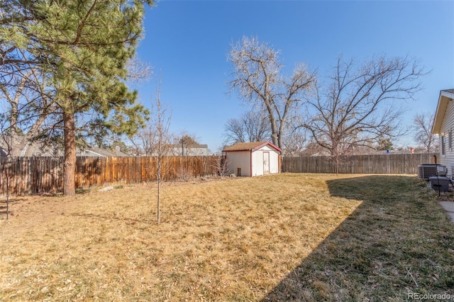 view of yard featuring a fenced backyard, a shed, and an outdoor structure