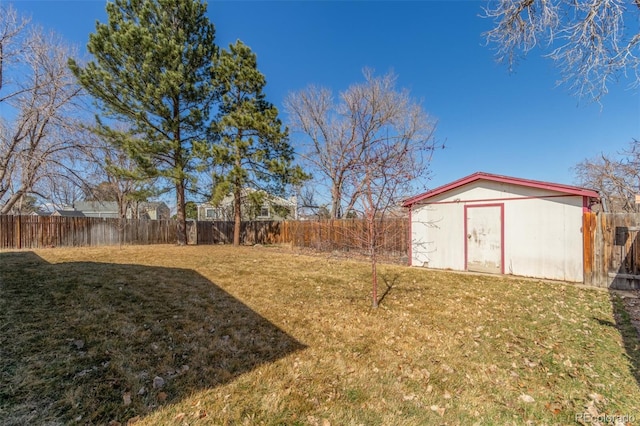 view of yard with a storage shed, an outbuilding, and a fenced backyard