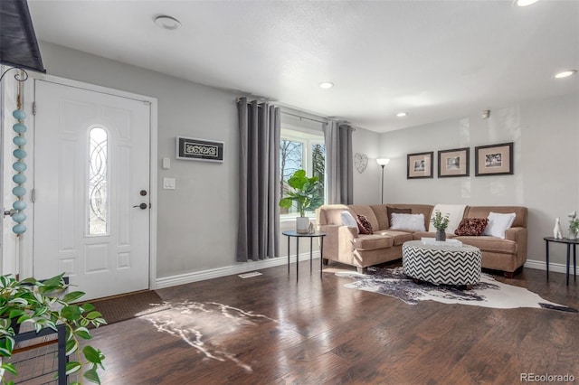 living room featuring recessed lighting, baseboards, and wood finished floors