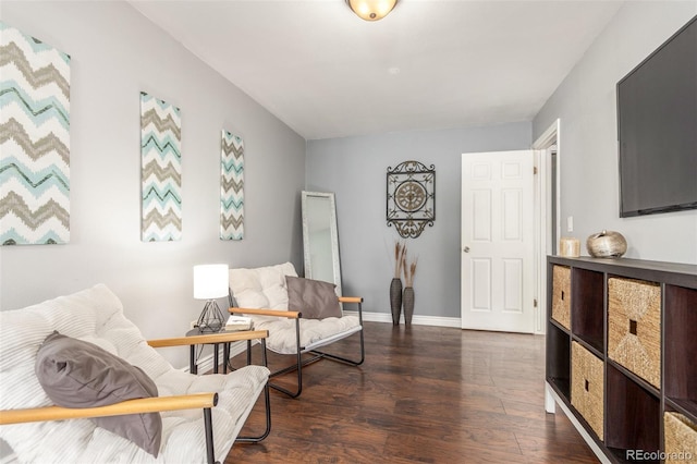 sitting room featuring baseboards and wood finished floors