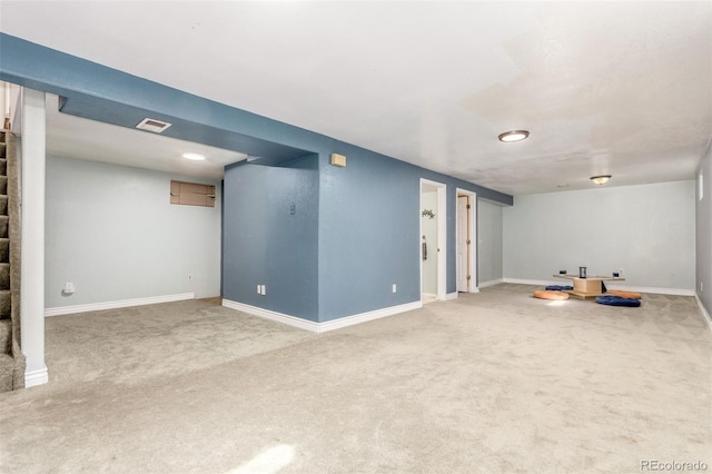 finished basement featuring carpet flooring, stairs, and baseboards