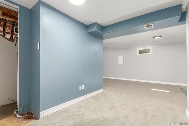 unfurnished room featuring baseboards, carpet floors, and visible vents