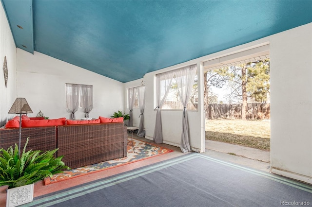 sunroom / solarium featuring vaulted ceiling