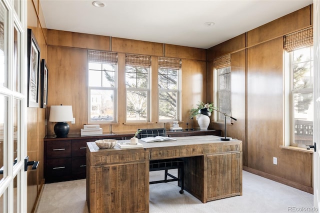 office area featuring light carpet and wooden walls