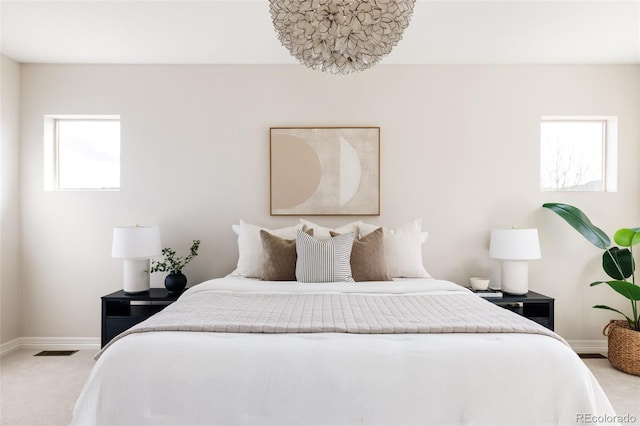 carpeted bedroom with baseboards and visible vents