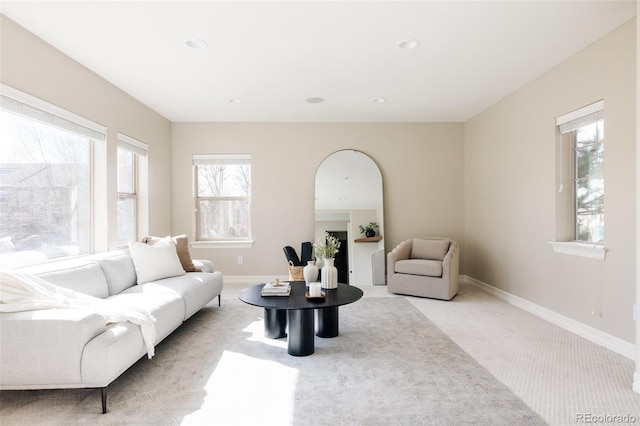 living area featuring light carpet, baseboards, and recessed lighting