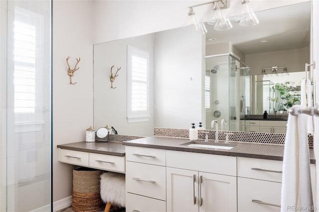 bathroom featuring a shower stall and vanity