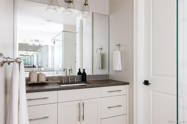 full bath with a stall shower and vanity