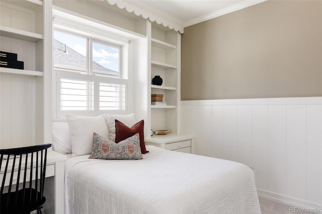 bedroom featuring ornamental molding and wainscoting