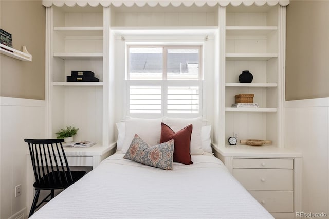 bedroom with a wainscoted wall