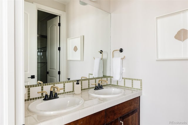 full bath with a sink, backsplash, and double vanity